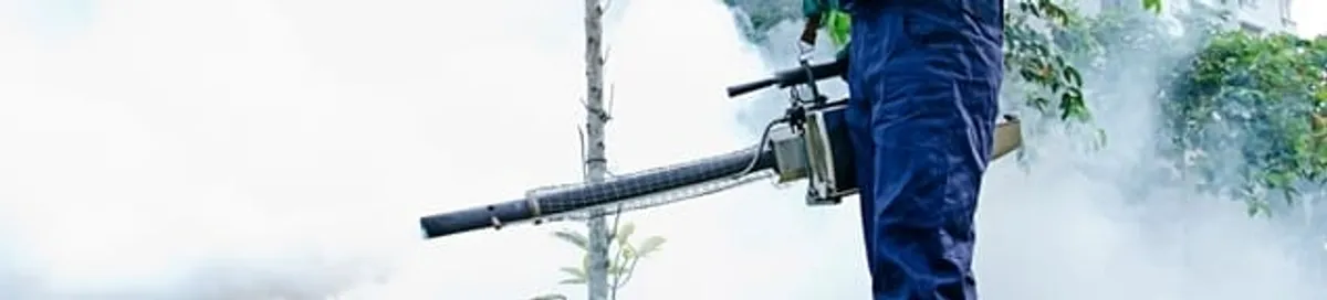 Pest control technician fogging an outdoor area for insect control in Myrtle Beach, SC
